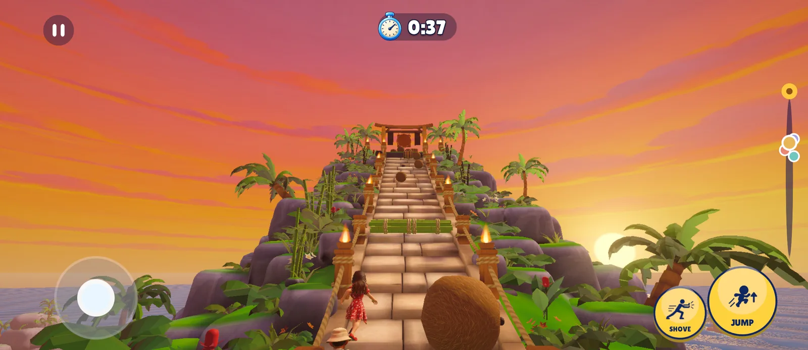 Players climbing a stone stair at sunset as coconuts roll down